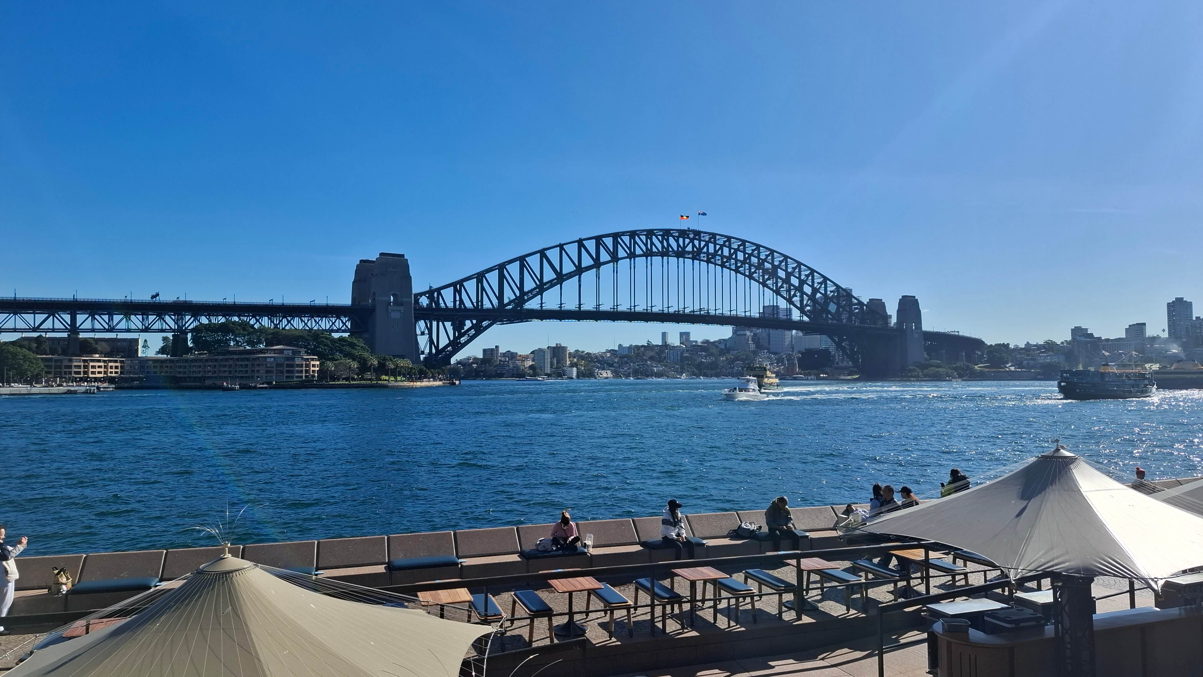 The Sydney Harbour Bridge, against a blue sky.